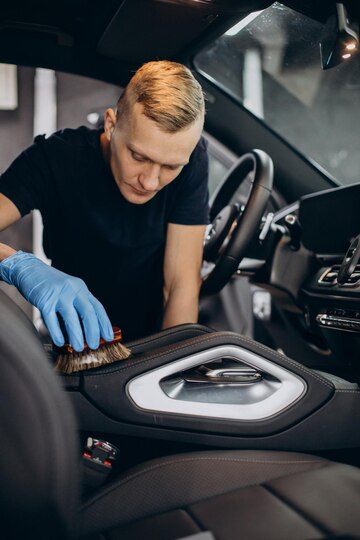 man-car-clean-using-brush-clean-up-all-details-inside-vehicle_1303-30586