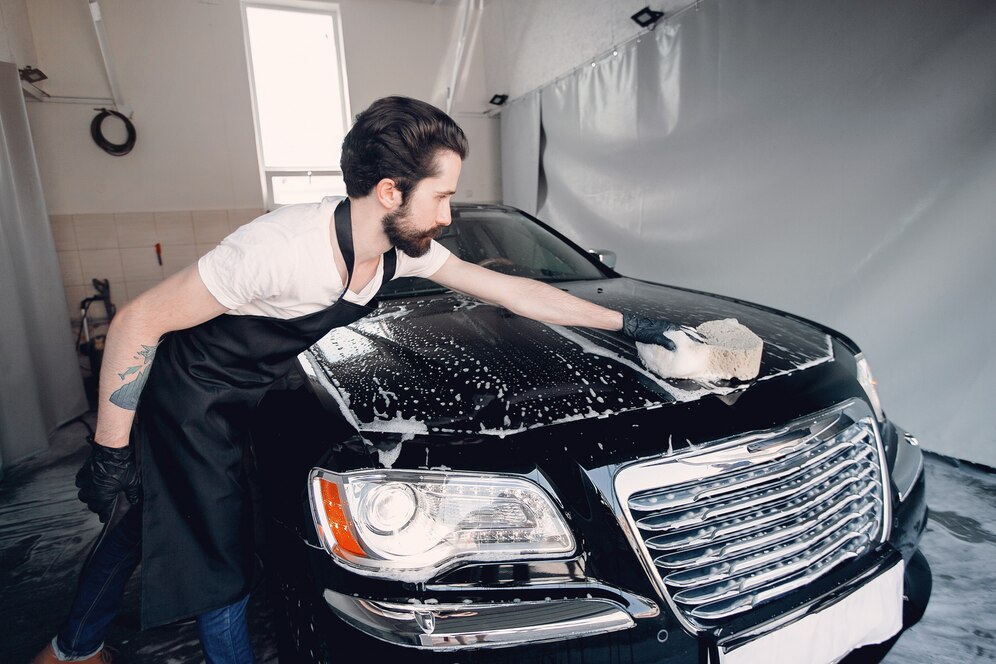 man-washing-his-car-garage_1157-26056